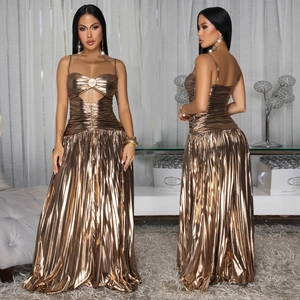 Detail of shimmering metallic pleated maxi dress with elegant cut-outs and gold finish