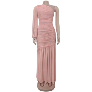 Detailed view of pink ruched mesh fabric on a one-shoulder maxi dress with long sleeves