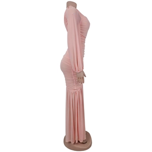 Side view of pink ruched bodycon dress showing detailed fabric folds and long sleeves