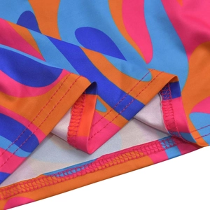 Close-up of double-stitched hem on colorful wave print ruffle dress fabric