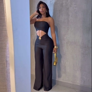 Women's black two-piece set featuring tube top and wide-leg trousers with gold floral buckles