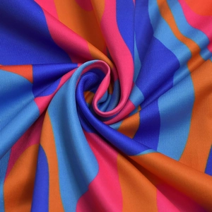 Close-up of vibrant wavy print fabric with ruffled texture and flexible polyester fibers