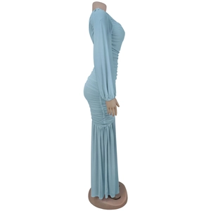 Detail of light blue long sleeve ruched dress showing side silhouette and fabric texture