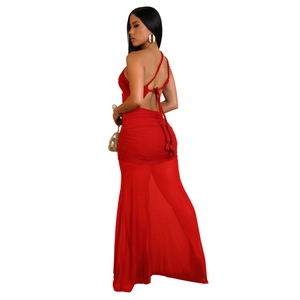 Detail of red backless halter maxi dress featuring woven straps and ruched mesh texture