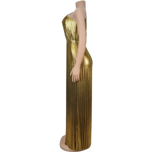 Detail of metallic gold pleated sleeveless long dress showing fabric texture and drape