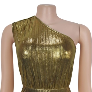 Detail of elegant gold one-shoulder dress showing metallic pleated fabric and waist design