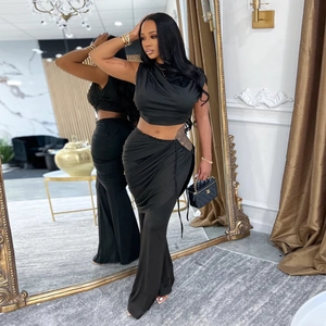 Chic black two-piece set featuring a sleeveless crop top and cutout high-waist pants