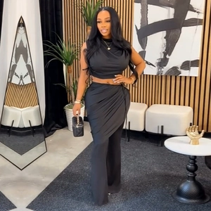 Three-piece set detail with sleeveless halter crop top, wrap skirt, and flared pants
