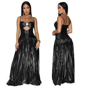 Detail of elegant black shimmering evening gown with thin straps and metallic ring cutout