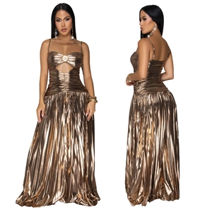 Detail of metallic bronze pleated maxi dress showing hollow-out bust with ring hardware