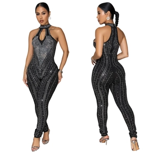 Elegante tuta nera aderente con strass, scollatura all'americana e aperture