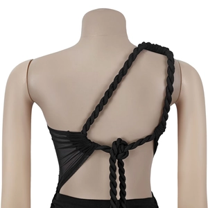 Detail of black one-shoulder dress showing braided rope straps and cutout back design