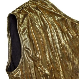 Detailed macro view of the gold pleated metallic fabric with fine vertical texture