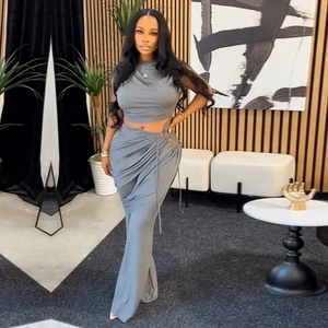 Detail view of grey two-piece set featuring a sleeveless crop top and a high slit maxi skirt