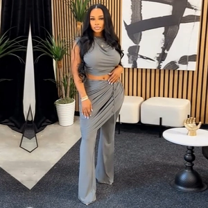 Detail view of grey two-piece set featuring sleeveless crop top and draped layering pants