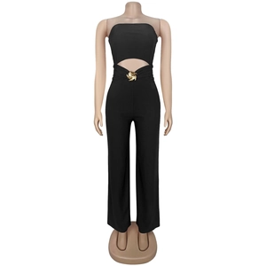 Detail of waist cutout with golden swirl buckle on black slim fit jumpsuit