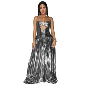 Detail of silver liquid metallic dress with spaghetti straps and circular chest ornament