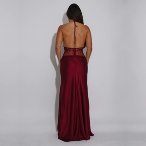 Macro detail of the wine red satin dress with backless design and floral lace splicing