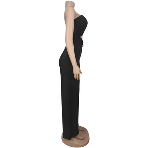 Detail of black strapless jumpsuit featuring side cut-out design and stretch fit fabric