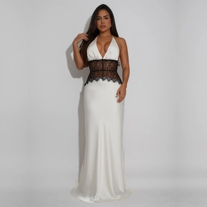 Detailed close-up of white satin dress featuring deep V-neck and black lace waist insert