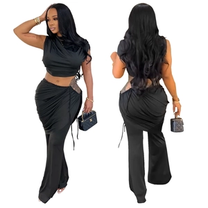 Three-piece black set featuring a crop top, drawstring skirt, and flared trousers detail