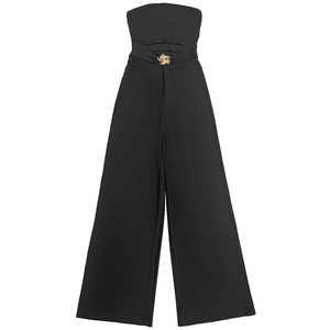Detail of black strapless jumpsuit featuring a gold spiral buckle and waist cutout