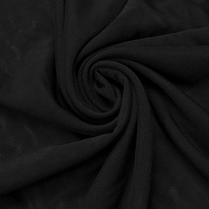 Close-up of black mesh fabric showing fine knit texture and soft drape for evening dresses