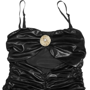 Detail of black glossy faux leather top with spaghetti straps and pearl buckle
