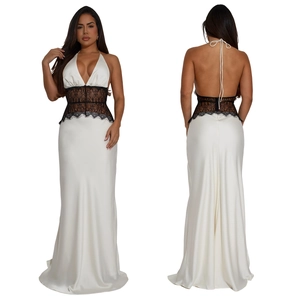 Detail of elegant white satin maxi dress featuring black lace patchwork and open back design