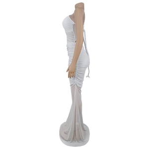 Detail of white slim fit dress with side ruching and sheer mesh mermaid hemline