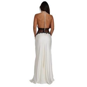 Detail of elegant backless evening dress with black lace bodice and white satin skirt
