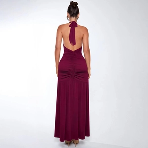 Detailed back view of burgundy backless halter maxi dress with ruched waist and bow tie