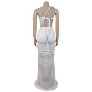 Detail of white backless dress featuring sheer mesh trim and rustic rope shoulder straps