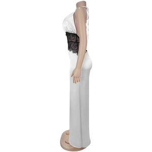 Detail of white satin maxi dress featuring elegant black lace patchwork on the waistline