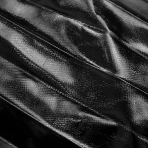 Close-up of black metallic pleated fabric with high-gloss texture for evening dresses