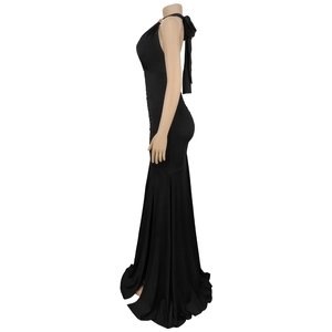 Detail of elegant black halter dress featuring a large decorative bow on the back