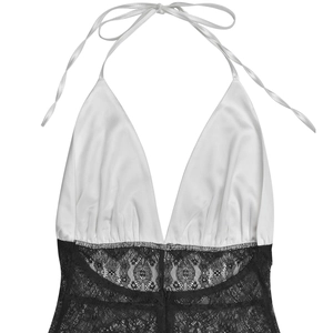 Detail of the plunging V-neckline with white satin and black floral lace patchwork
