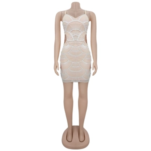 Detail of sequins shell pattern and pearl trim on a sexy v-neck party mini dress