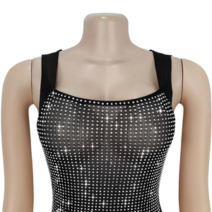 Detailed view of black mesh dress with silver rhinestones and square neckline finish