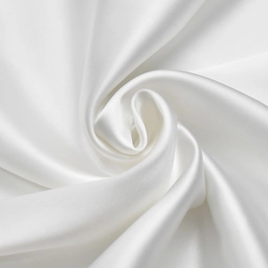 Detail shot of white silk satin fabric showing glossy texture and elegant draping