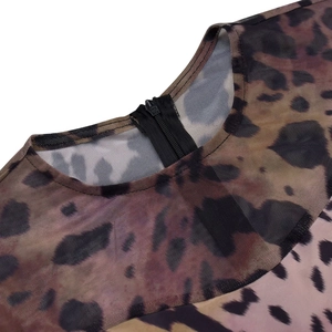 Close-up of leopard print mesh fabric with a durable black back zipper closure