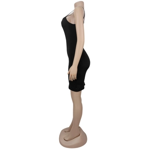 Detail of a black bodycon mini dress with thin straps made of elastic knitted fabric