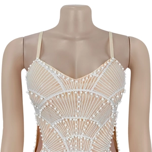 Detail of sequin embroidery and pearl embellishments on a nude V-neck strap dress