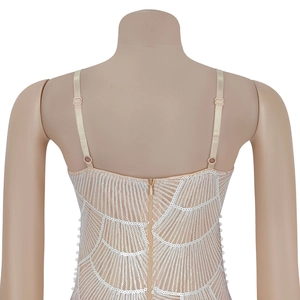 Detail of sequin pattern and adjustable straps on nude mesh mini dress with pearls