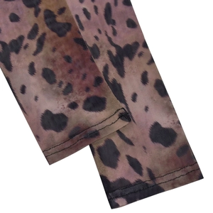Detail of leopard print mesh fabric with high-quality double-stitch sewing at the sleeve cuff