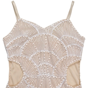 Close-up of pearl beads and white sequins on a beige cutout cocktail dress