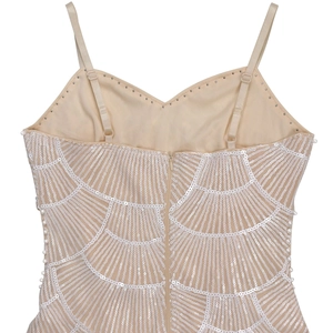 Close-up of beige sequin dress featuring scalloped patterns and adjustable straps