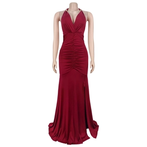 Detail of wine red halter dress featuring deep V-neck and ruched fabric with a side slit