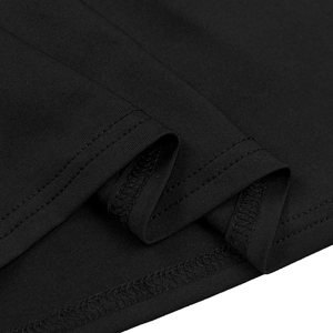 Detailed view of black knitted dress hem with high-quality stitching and fabric texture
