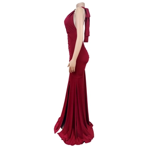 Detail of burgundy evening gown showing neck metal accents and elegant back bow tie design